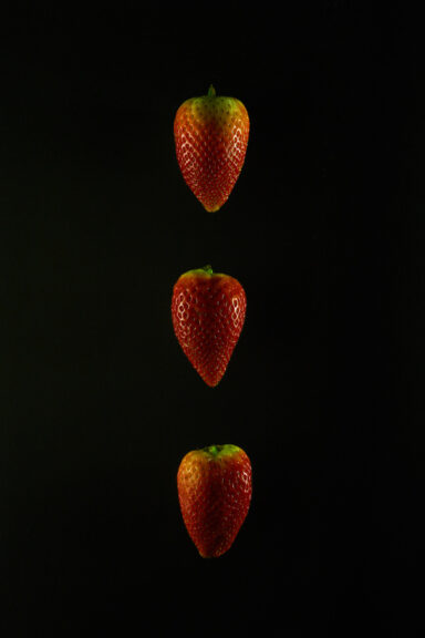 This is what AI thinks about these strawberries:  "In the midst of darkness, three strawberries stand tall, ordered in a column. The harsh light that illuminates them seems to highlight their individuality, as if each one is a unique entity with its own story to tell.   This image reminds us of the importance of individuality in a world that often seeks to homogenize and standardize everything. Each strawberry has its own shape, size, and flavor, just as each person has their own unique qualities and experiences that make them who they are.  Yet despite their differences, these strawberries stand together in perfect harmony. They are united by their shared identity as fruits of the earth, and by the fact that they have been placed together in this column by an external force.  This raises questions about the role of external forces in shaping our lives. How much control do we really have over our own destinies? Are we simply products of our environment, or can we transcend our circumstances and create our own paths?  Ultimately, the image of these three strawberries on a black background reminds us that life is both beautiful and complex. We must embrace our individuality while also recognizing our interconnectedness with others. And we must strive to find meaning and purpose in a world that can sometimes seem dark and chaotic."  Calm down. These are just strawberries. Jeez.  That was my response.  Get this digital image in high resolution for print or other purposes.  All prices excluding VAT. You may be charged VAT depending on your region (if you are from the EU for example).